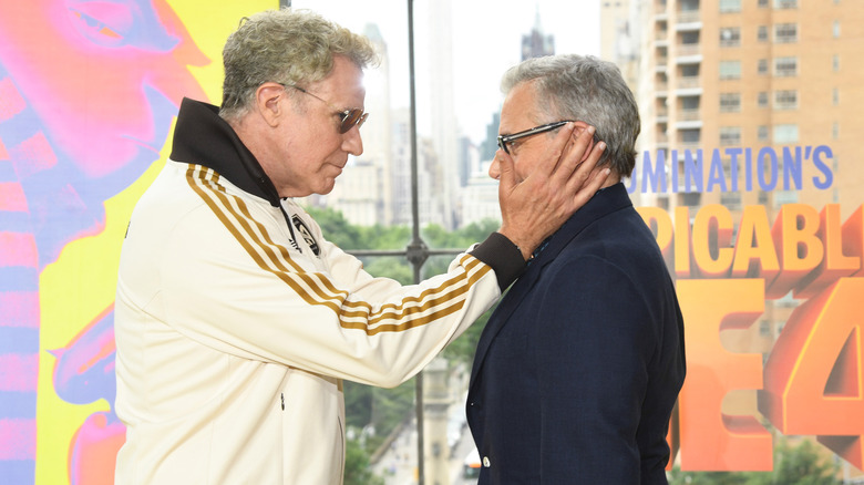 Will Ferrell holds Steve Carell