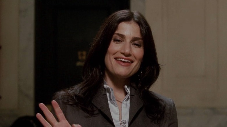 Idina Menzel grinning and waving