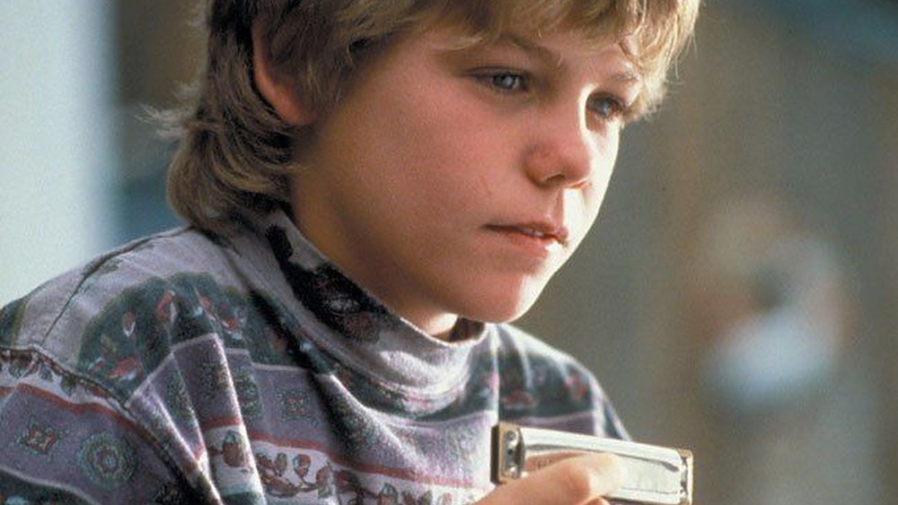 Jason James Richter as Jesse with his harmonica in Free Willy