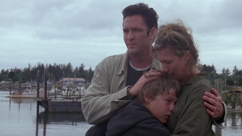 Jayne Atkinson as Annie Greenwood, Michael Madsen as Glen Greenwood, and Jason James Richter as Jesse embrace in Free Willy