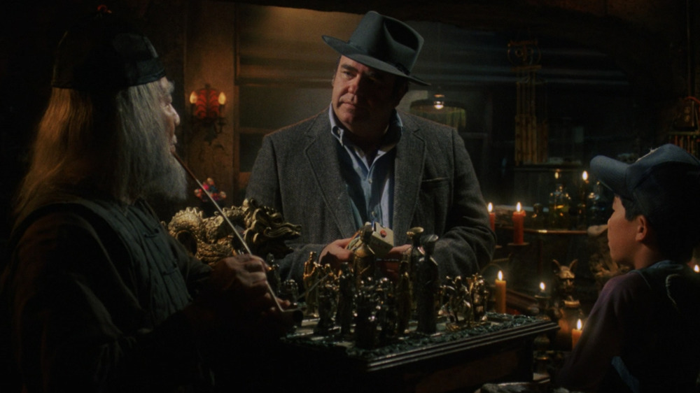 Keye Luke as Mr. Wing, Hoyt Axton as Rand Peltzer, and John Louie as Mr. Wing's grandson in Gremlins