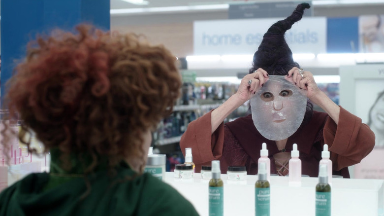 Kathy Najimy holds up face mask