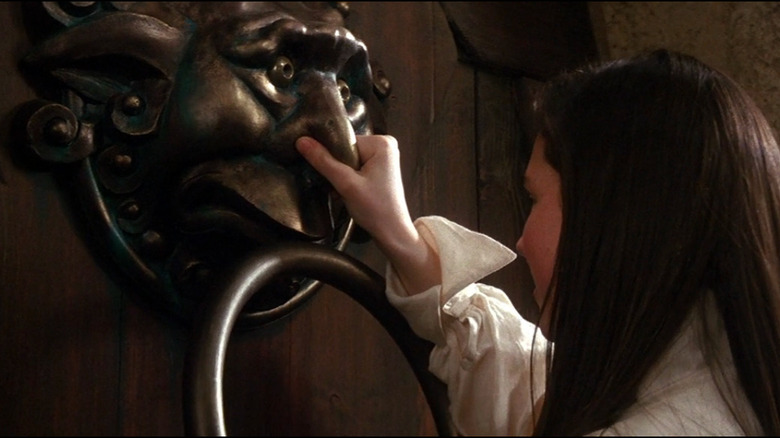 Sarah puts the ring back in the door knockers mouth in Labyrinth