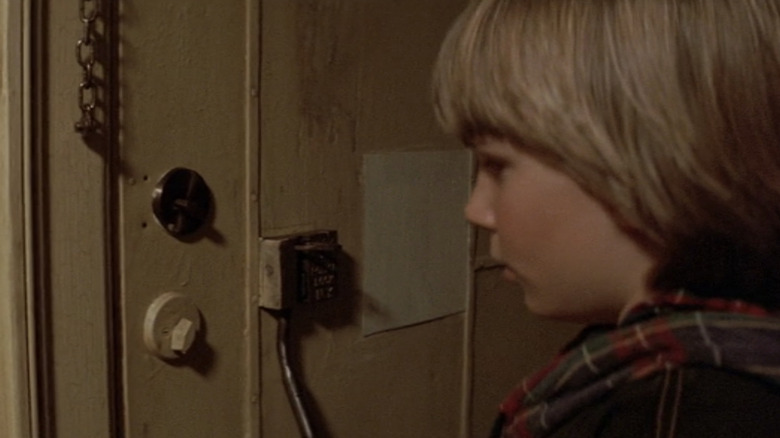 Danny looking at door locks in Last Action Hero 