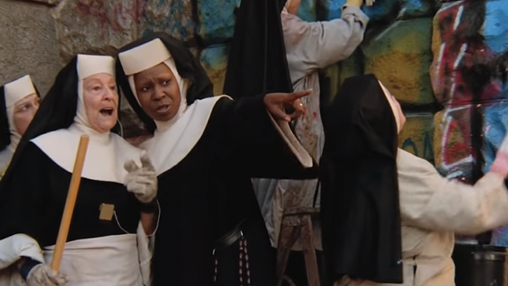 Delores points while nuns paint