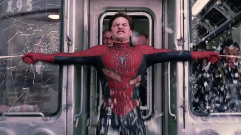 Spider-Man strains while trying to stop a commuter train