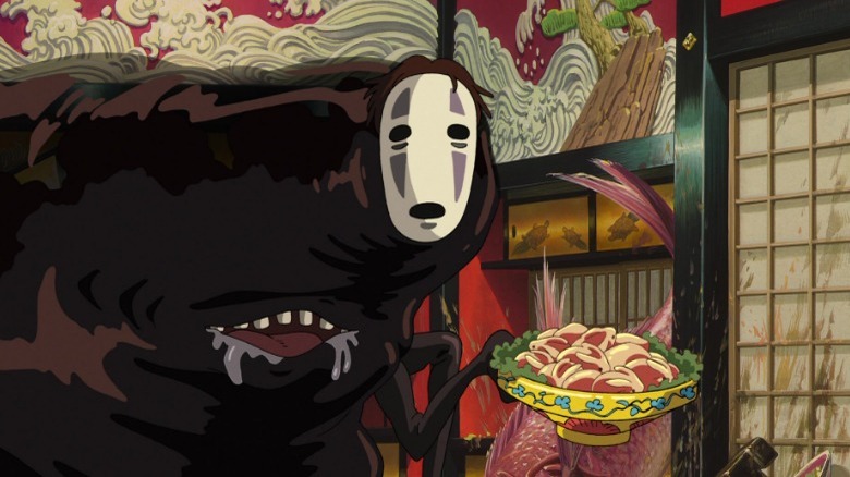 No-Face holding bowl of food