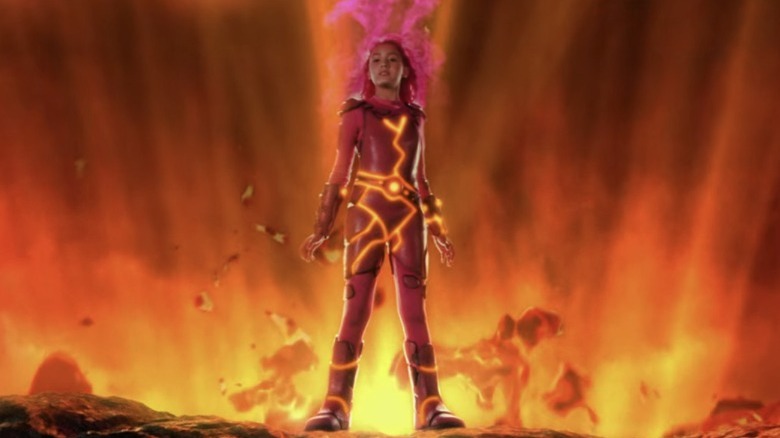 Lavagirl stands in front of a volcanic eruption