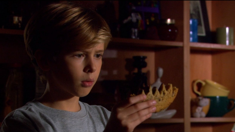 Max holds up a cookie with jagged teeth marks