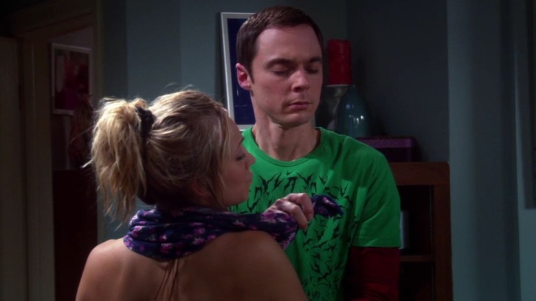 Sheldon helps Penny get dressed in "The Adhesive Duck Deficiency"