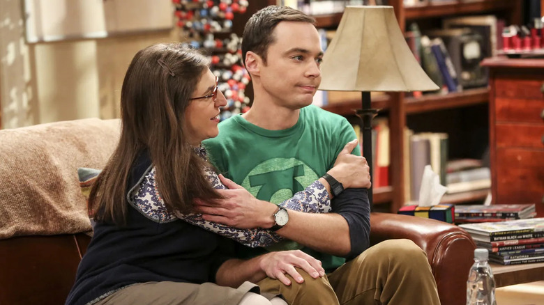 Amy hugs Sheldon on the couch in "The Cohabitation Experimentation"