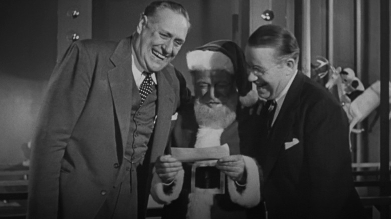 R.H. Macy and Mr. Gimbel laugh with Kris Kringle