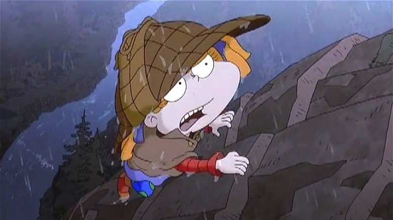 angelica climbing a cliff in the rain