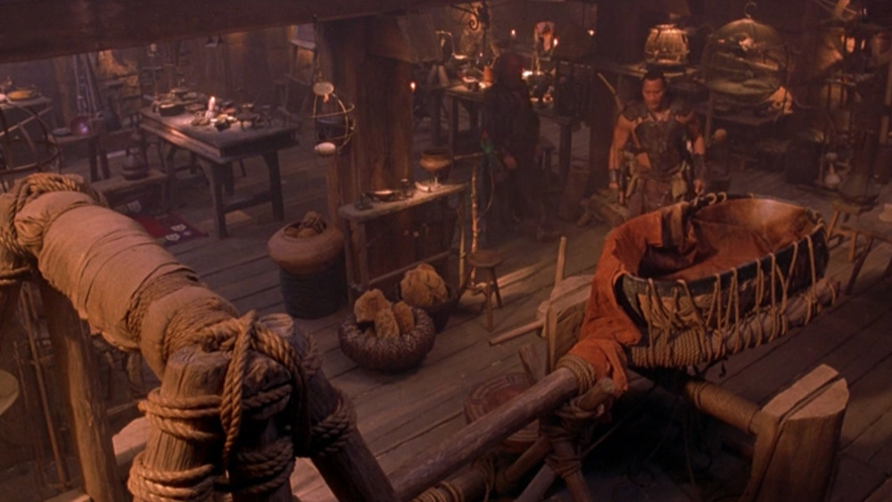 The Rock as Mathayus, inspecting weaponry in The Scorpion King