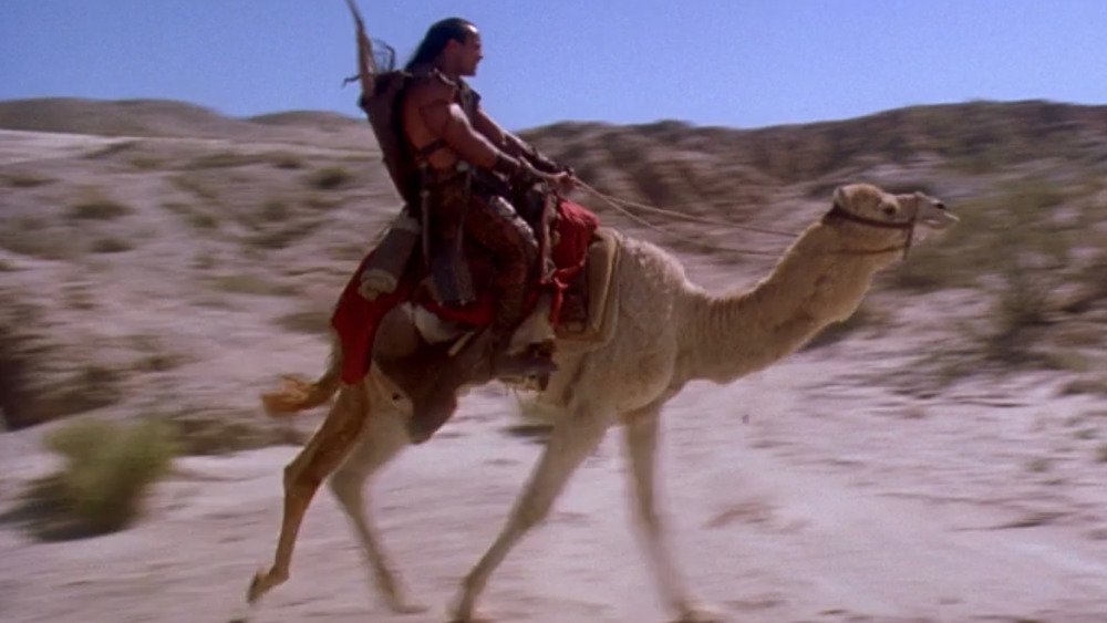 Dwayne "The Rock" Johnson as Mathayus and his camel, in The Scorpion King