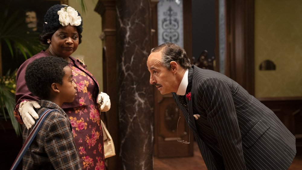 Octavia Spencer as Grandma and Jahzir Kadeem Bruno as Charlie greet Stanley Tucci as Mr. Stringer in The Witches