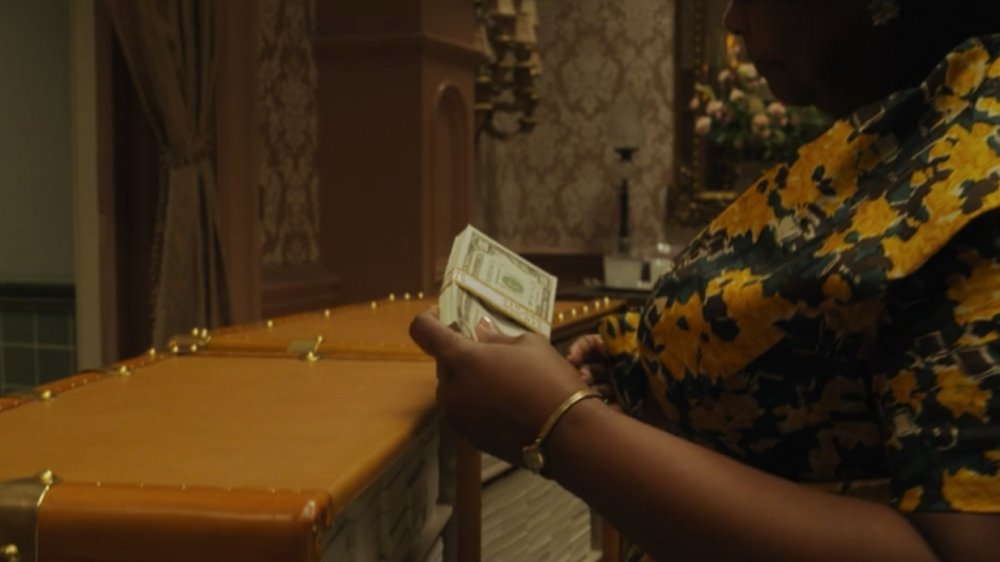 Octavia Spencer as Grandma, holding the Grand High Witch's cash in The Witches