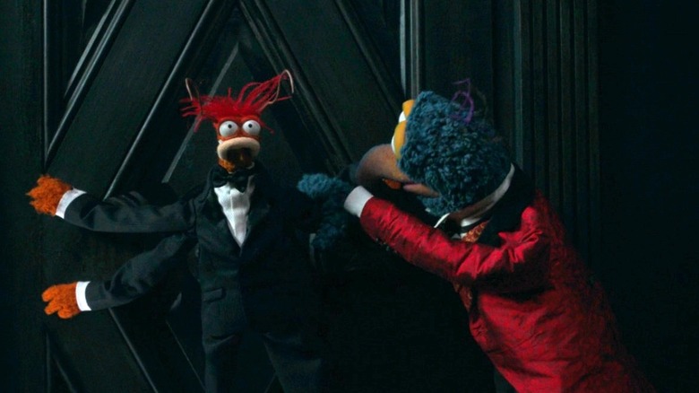 Gonzo peeling Pepe off a door in the Haunted Mansion