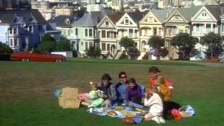 Tanner family picnicking outside Victorian homes