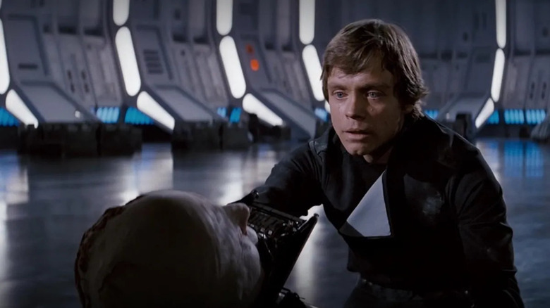 Luke leaning over maskless Vader