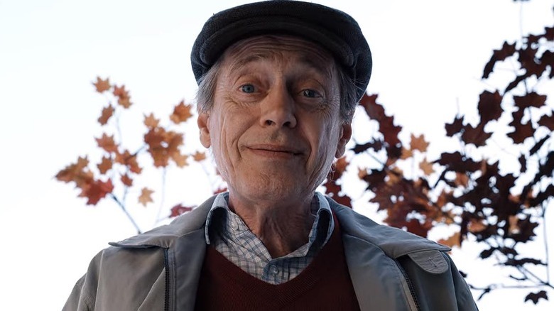 Walter stands in front of autumn leaves