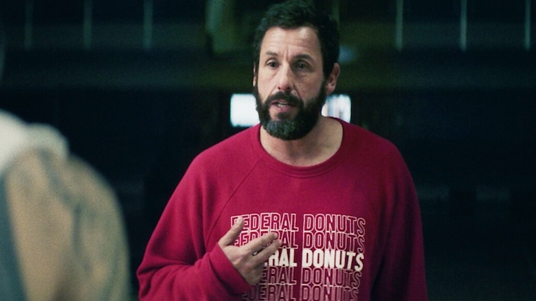 Stanley gestures emphatically in a shirt reading "Federal Donuts"