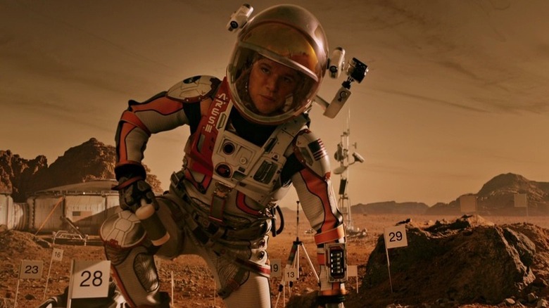 Matt Damon kneels in spacesuit