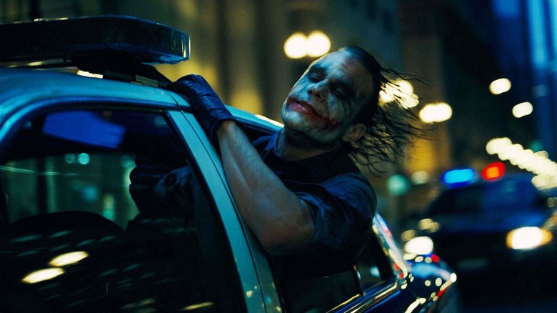 Heath Ledger hanging out of a police car