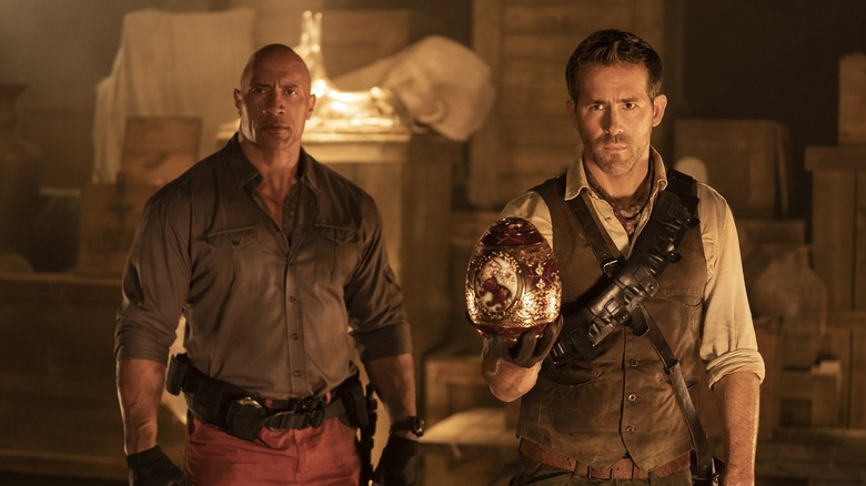 Dwayne Johnson and Ryan Reynolds with treasure