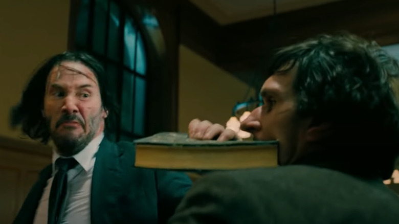 John Wick prepares to demolish a guy with a book