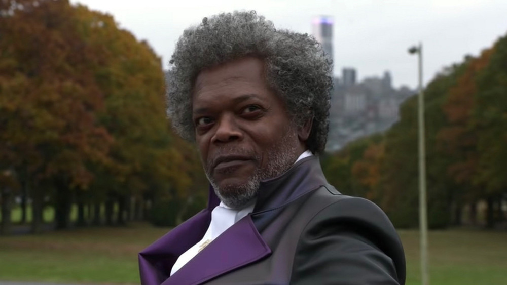 Mr. Glass wearing purple jacket