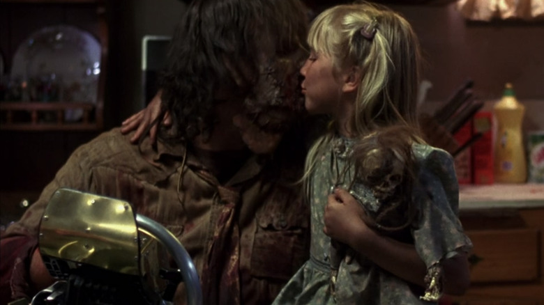 Little girl kisses Leatherface on the cheek