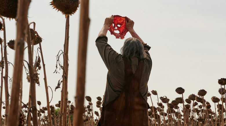 Leatherface holds up skinned face