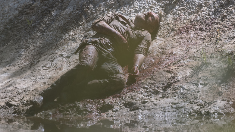 Rick lying on river shore