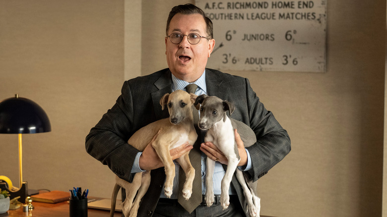 Higgins holds two dogs