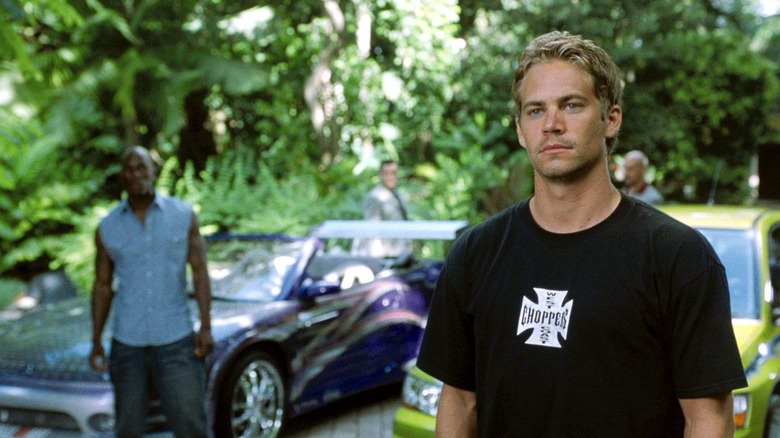 Brian stands in front of a car