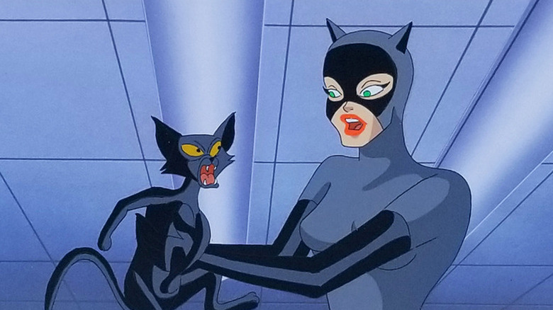 Catwoman holds a cat