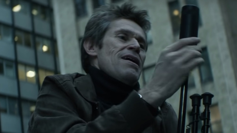 Willem Dafoe with sniper rifle