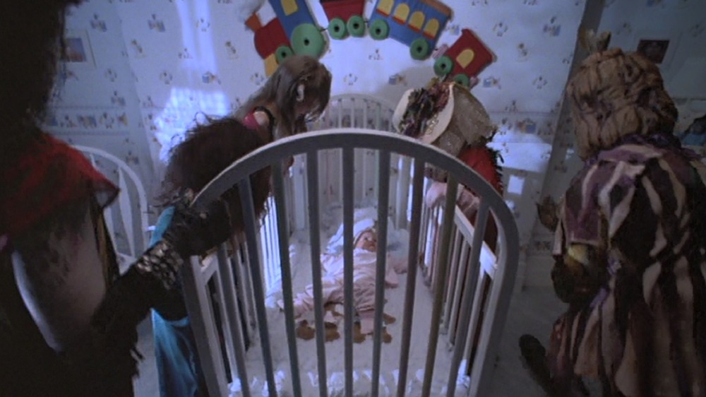 Monsters peer into a baby's crib in Little Monsters