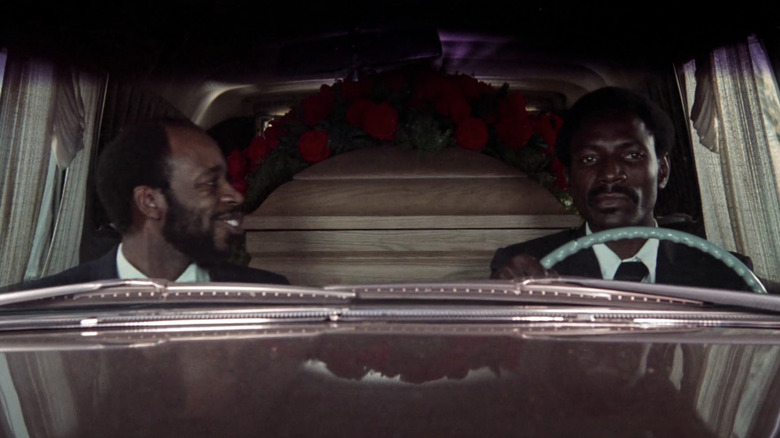 Two men driving hearse