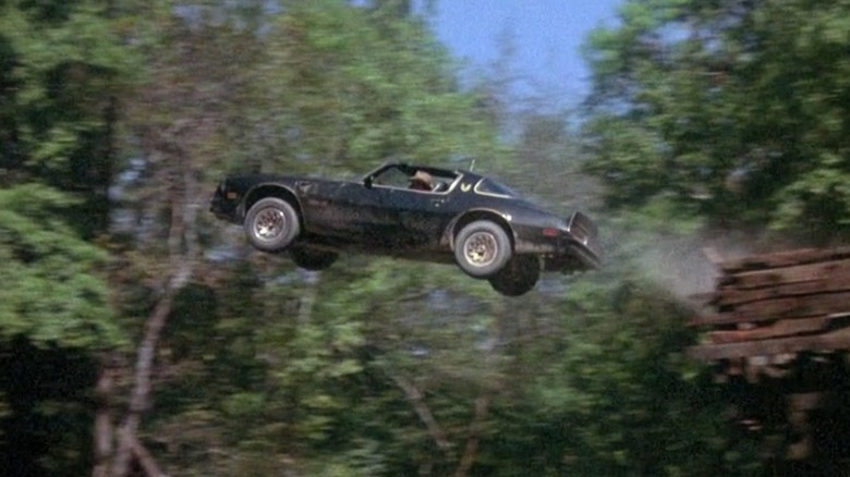 Bandit jumping Trans Am over river