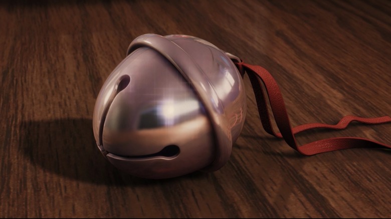 A bell with a ribbon sitting on a table