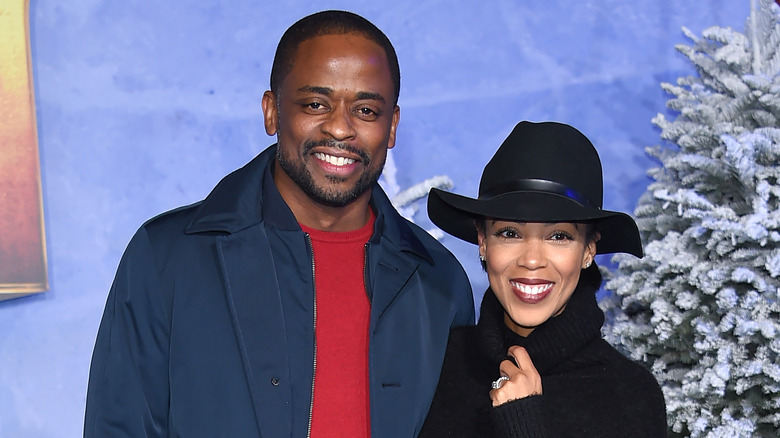 Dulé Hill and Jazmyn Simon by Christmas tree