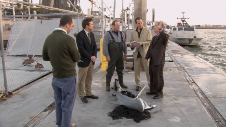 Characters on pier with shark