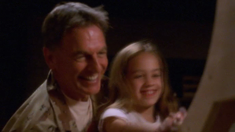 Mark Harmon and Mary Mouser smiling working on a boat