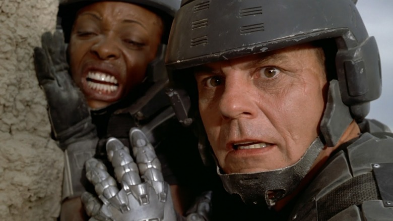 Michael Ironside and a soldier looking in fear