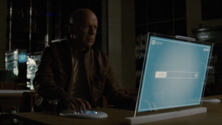 Bruce Willis looks at computer