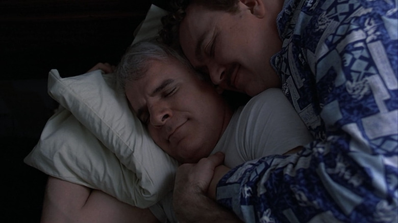 Neal and Del cuddling in bed