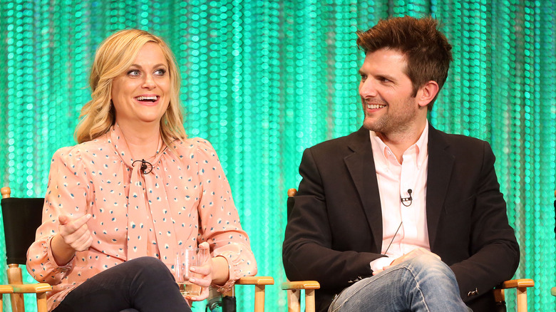 Adam Scott looking at Amy Poehler during a "Parks and Rec" panel