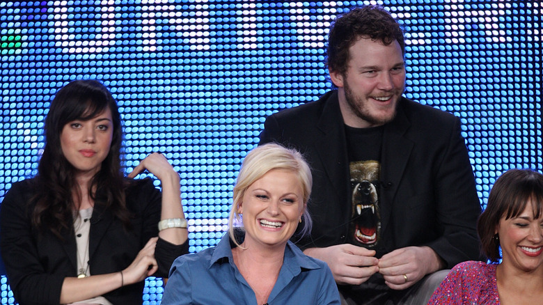 Chris Pratt sitting with Aubrey Plaza, Amy Poehler, and Rashida Jones at a panel